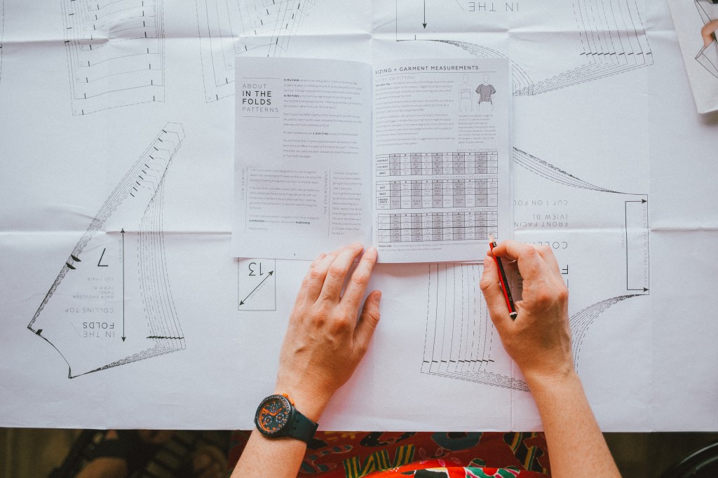 Emily Hundt from In the Folds, editing an instruction booklet for one of her sewing patterns